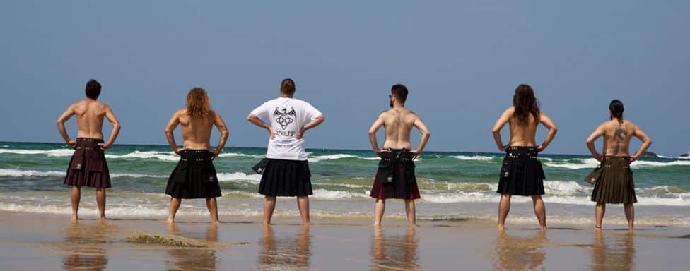 man holding a saw wearing ozkilts kilt